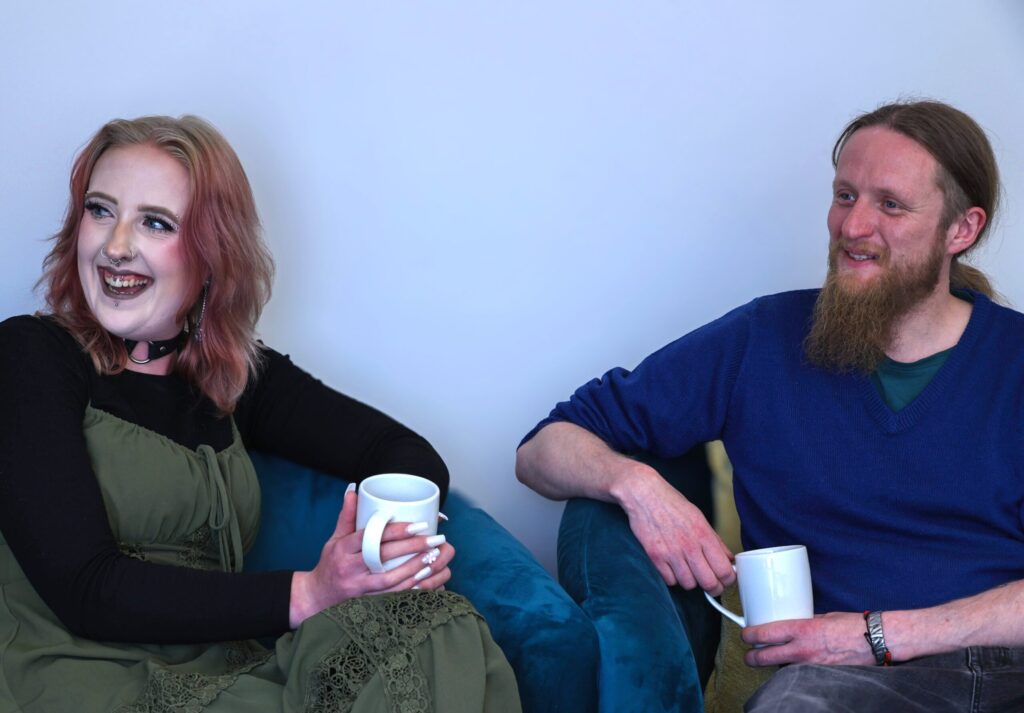 Two people chatting over a hot drink at the Discovery College