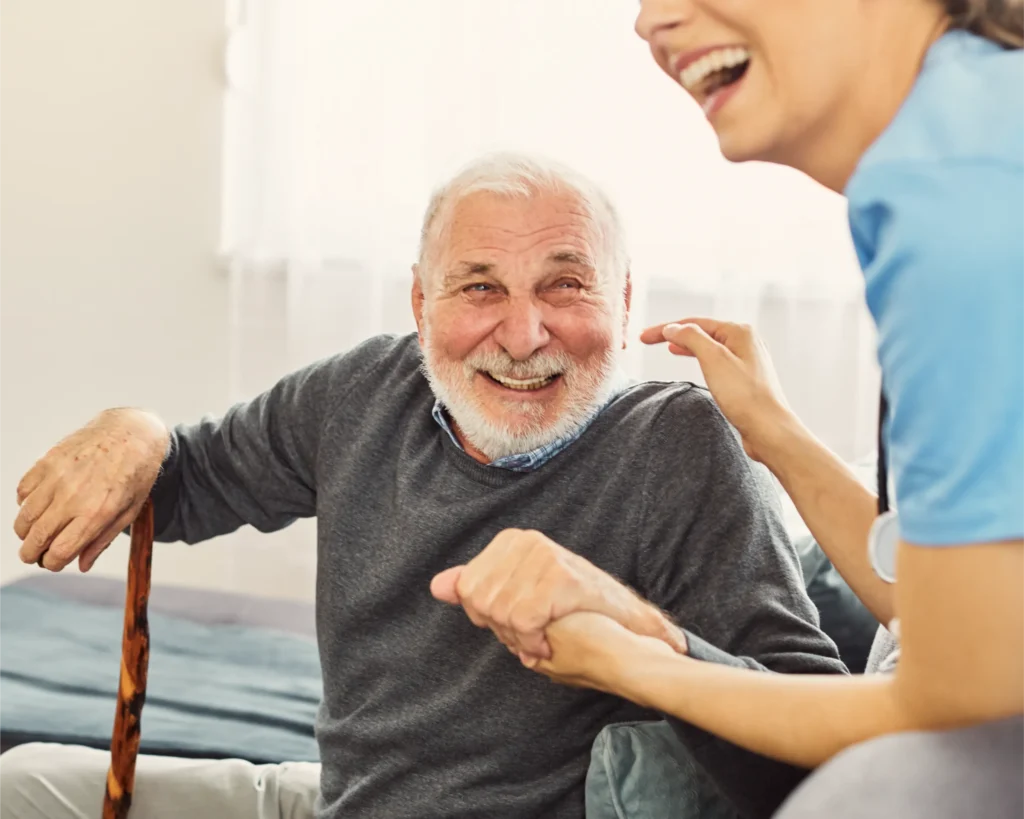 Centred carer with a smiling older man at home