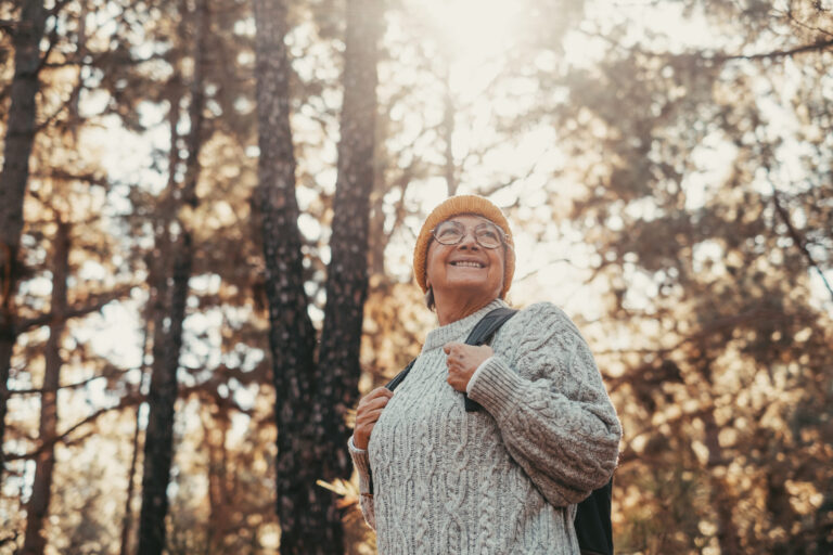 A woman walking through a Highland forest