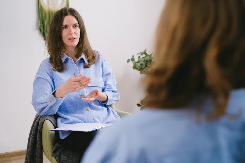 A woman talking with a support worker
